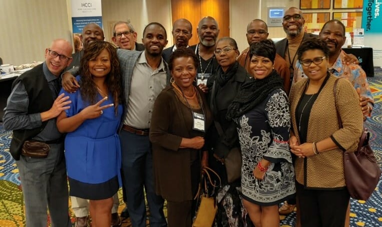 A group of men and woman, smiling at the camera. Project Choice landing page.